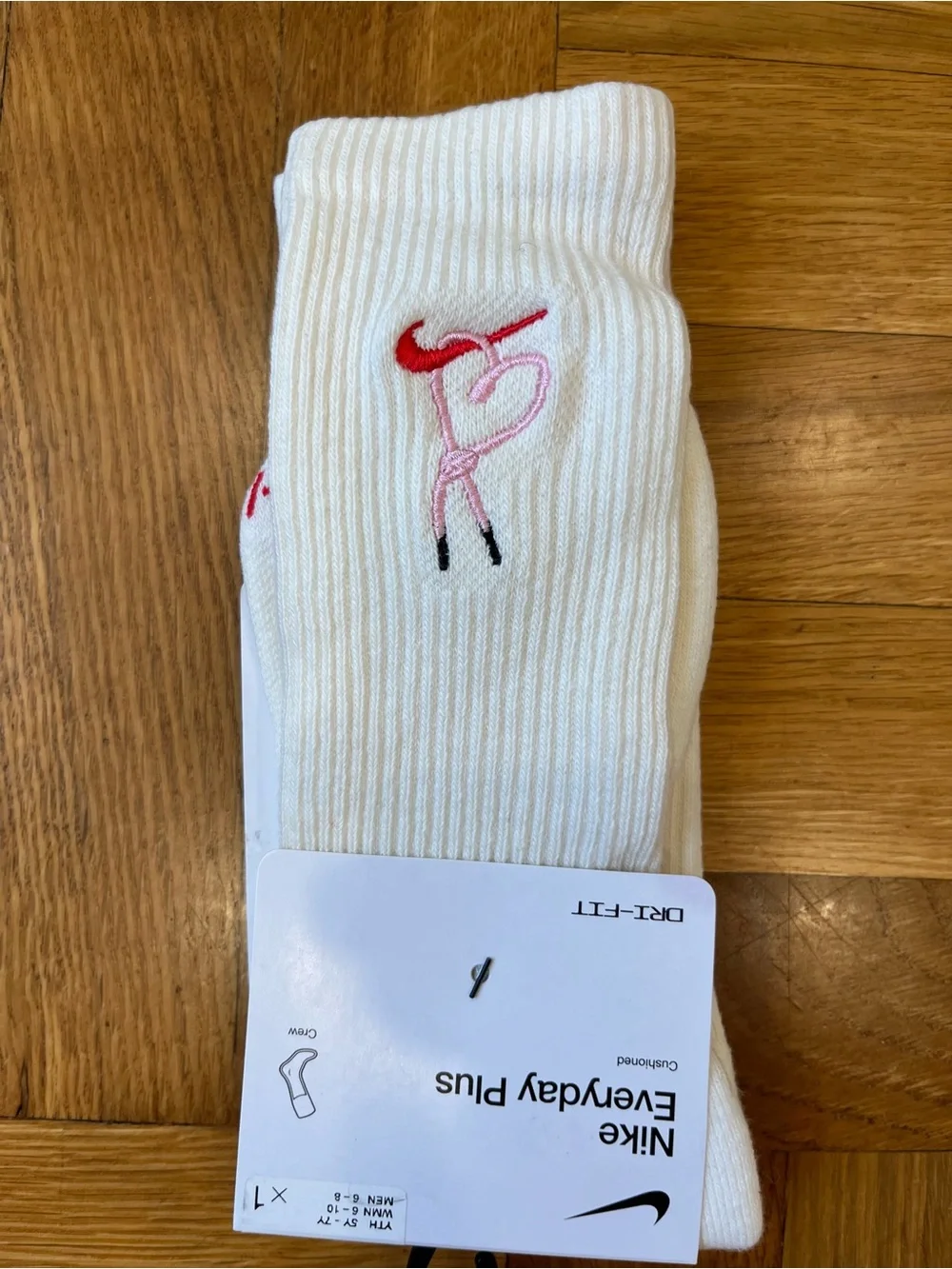 Nike White Crew Socks with Pink and Red Swoosh Accent